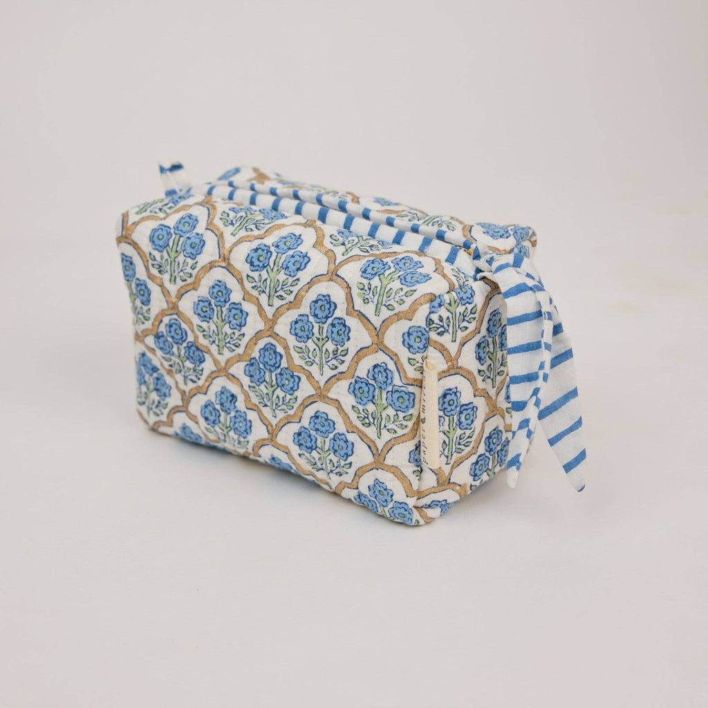 Fabric pouch with blue floral and striped pattern on a light gray background
