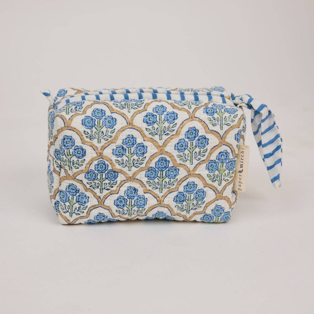 Fabric pouch with blue floral pattern on a light gray background