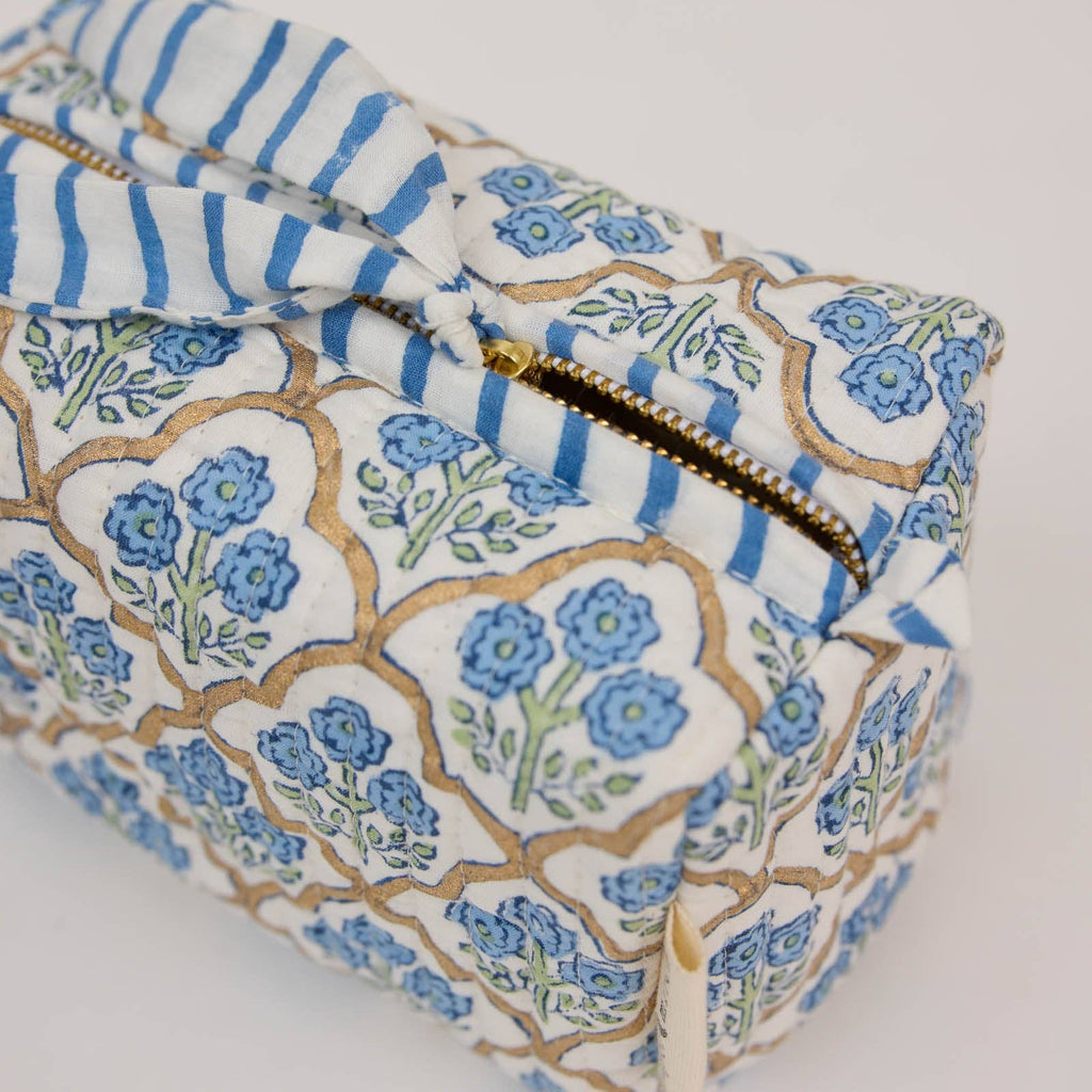 Rectangular fabric pouch with floral pattern and blue stripes on a white background