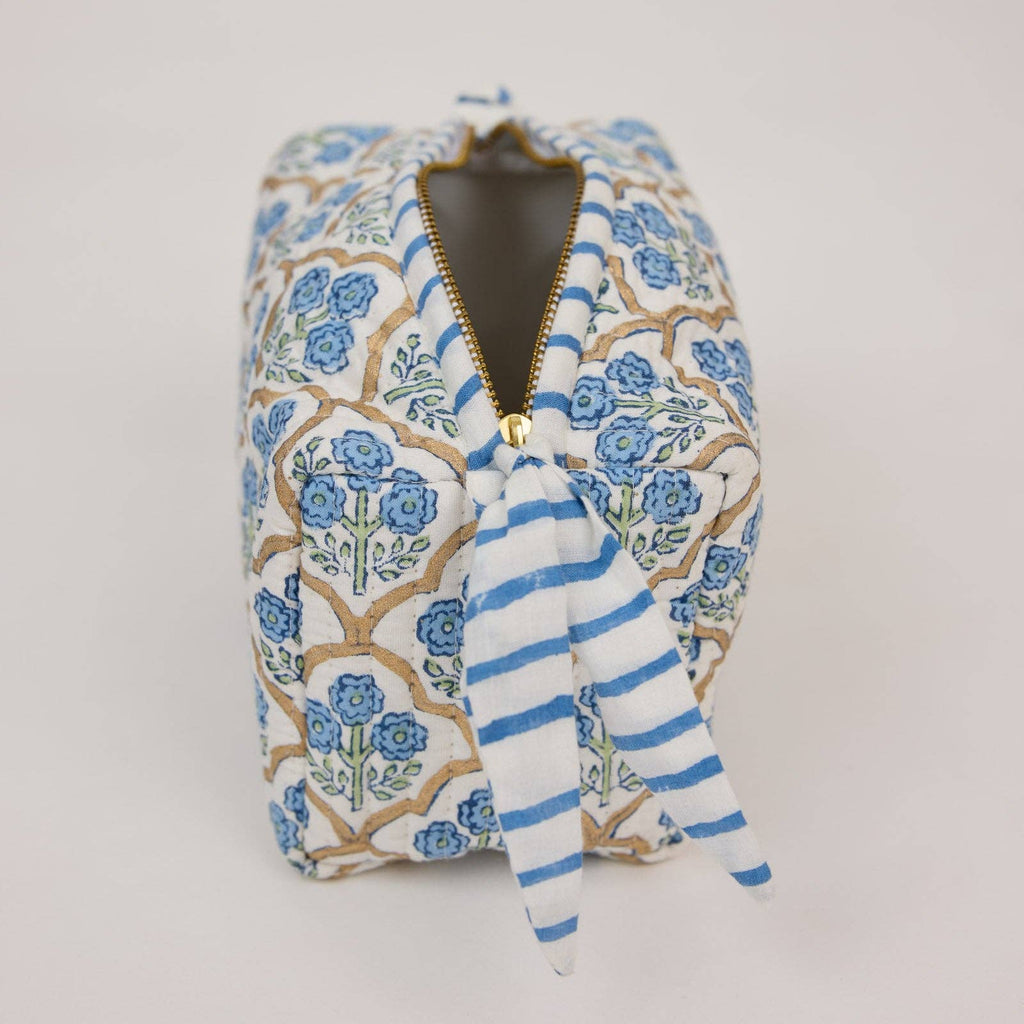 Floral-patterned pouch with blue stripes and a zipper on a light gray background