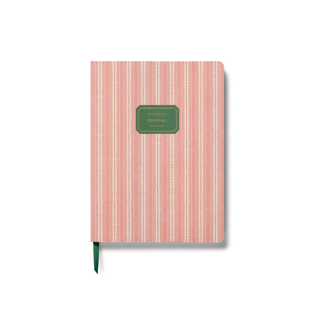 Notebook with pink and white striped cover and green label on a white background