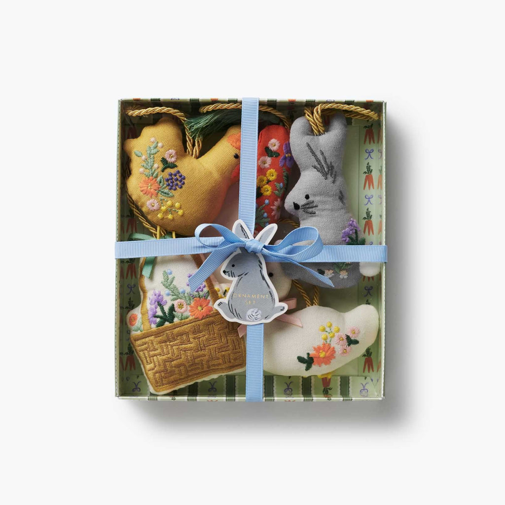 Set of decorative items including a heart, rabbit, and basket in a gift box with a blue ribbon.