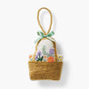 Decorative basket with flowers and a green ribbon on a white background