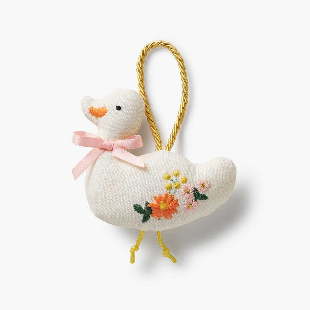 Decorative duck ornament with floral embroidery on a white background