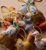 Collection of embroidered felt toys including a duck, rabbit, and basket on a beige background.