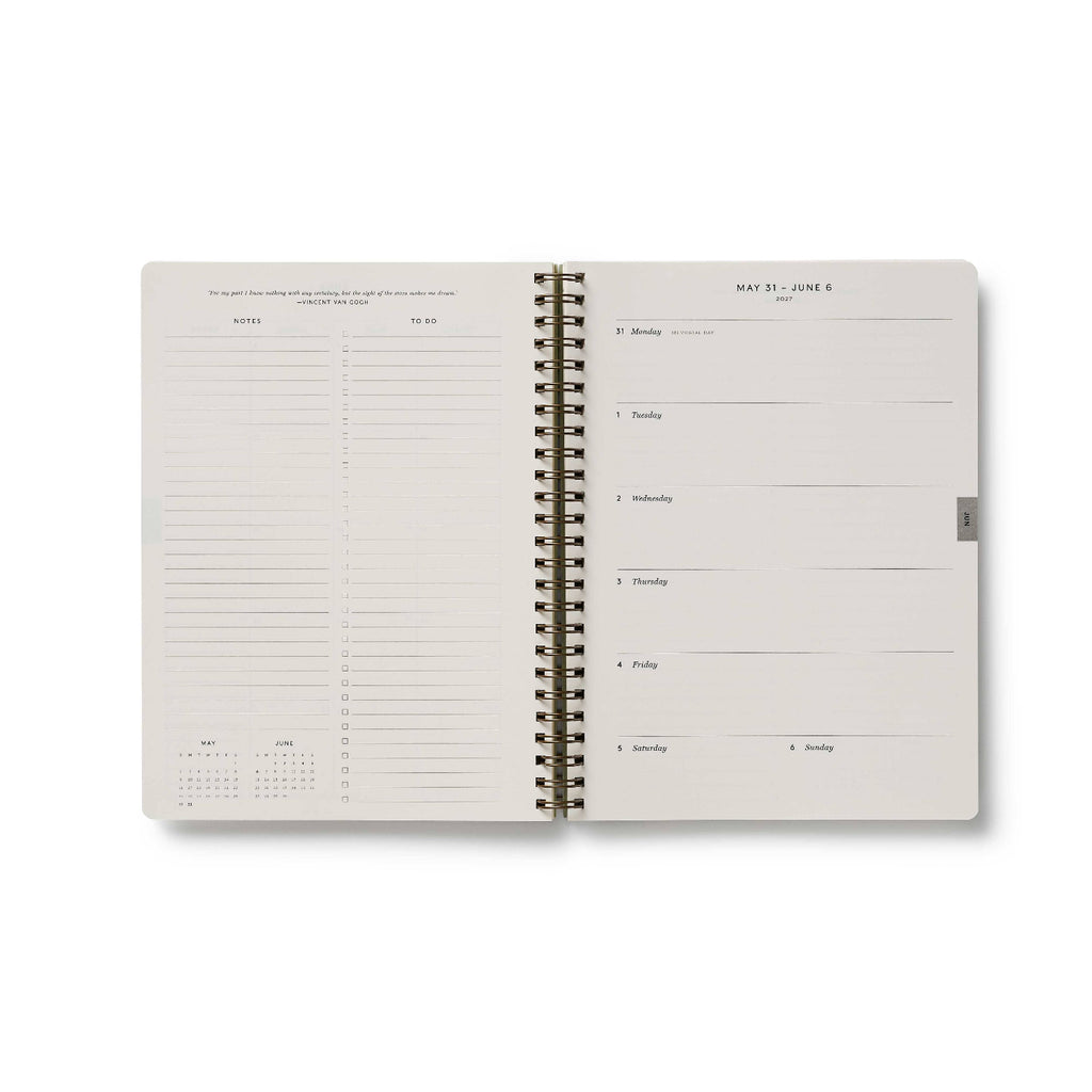 Spiral-bound planner with a grid layout on a white background