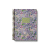 Floral patterned notebook with a green label on a white background