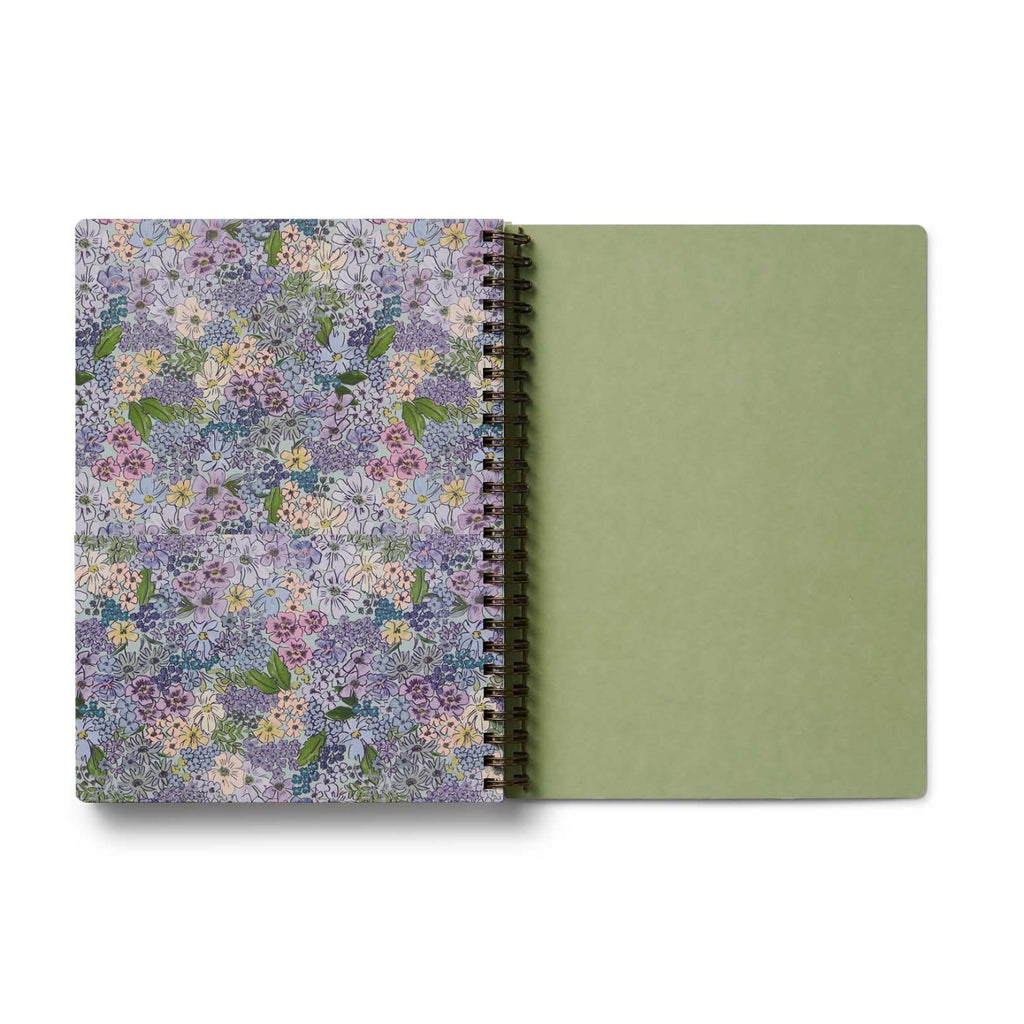 Notebook with floral cover and green back cover on a white background