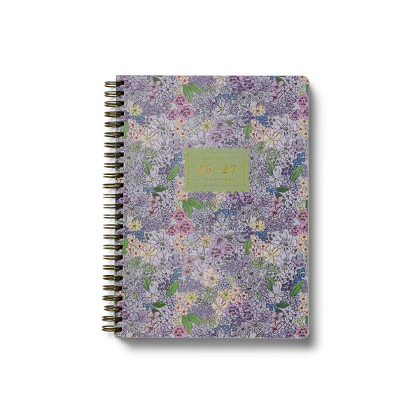 Floral patterned notebook with a green label on a white background