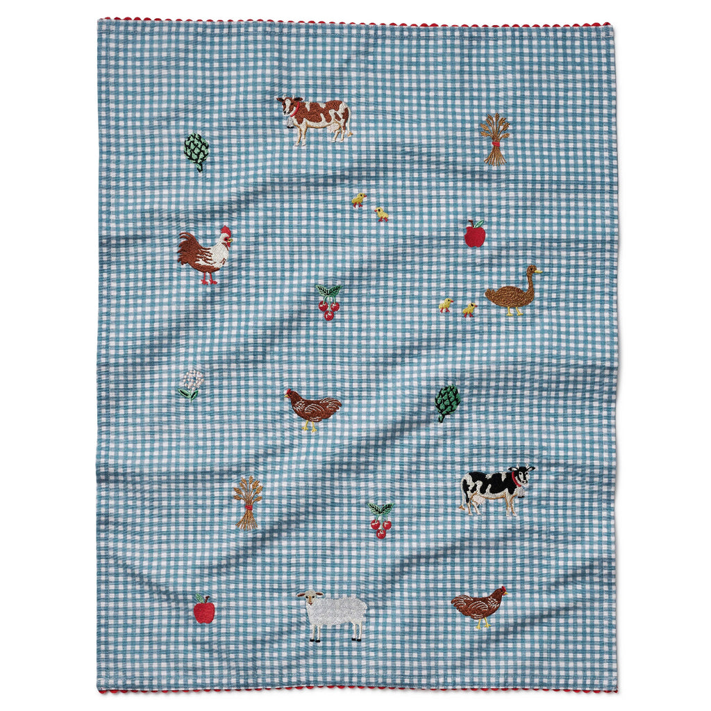 Checkered fabric with farm animal and vegetable patterns on a white background