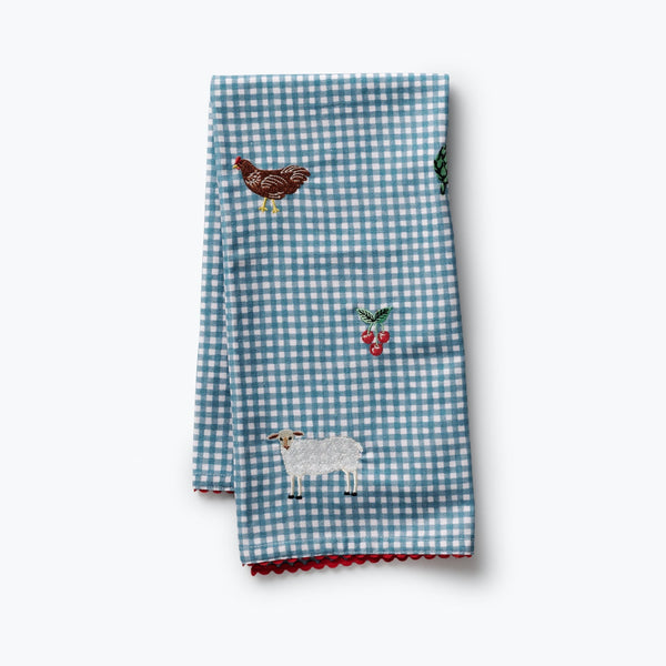 Two blue checkered towels with embroidered animals on a white background