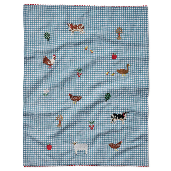 Checkered fabric with farm animal and vegetable patterns on a white background