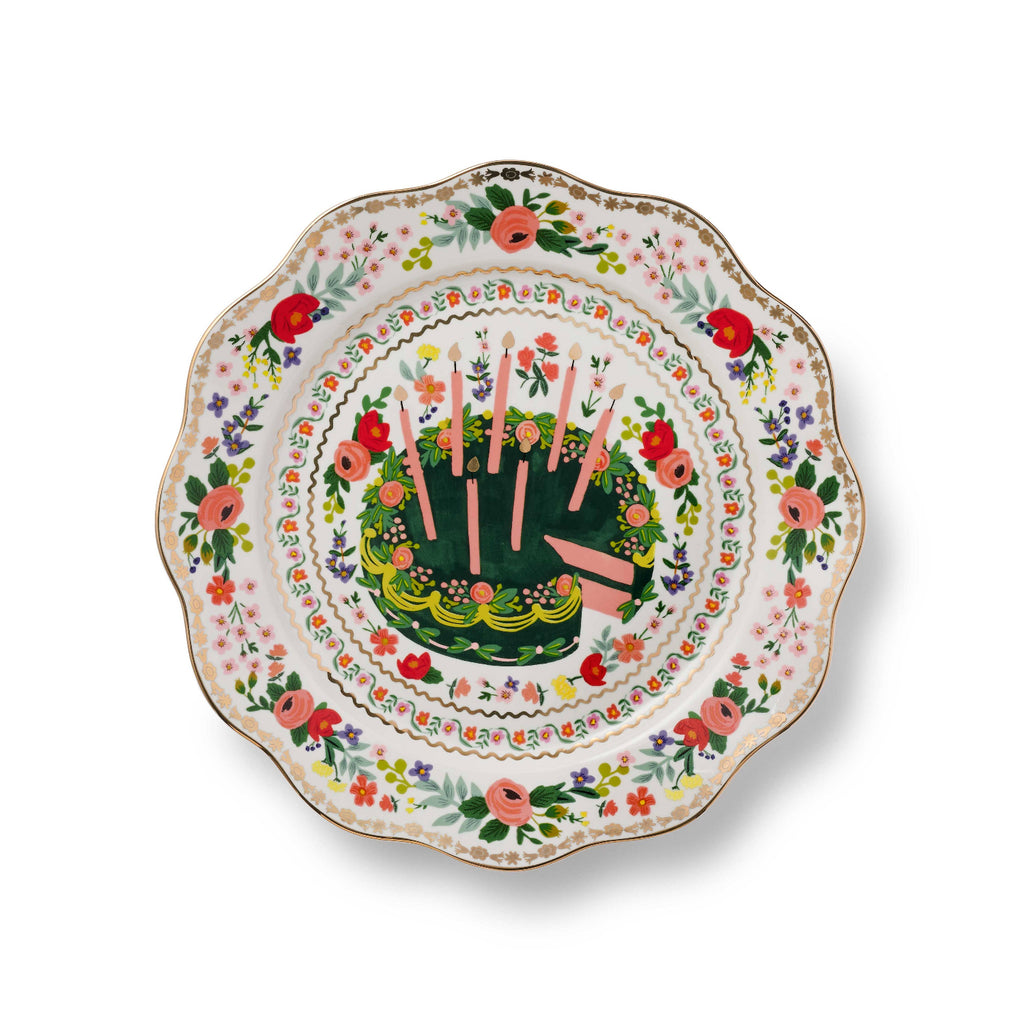 Decorative plate with floral design and cake illustration on a white background