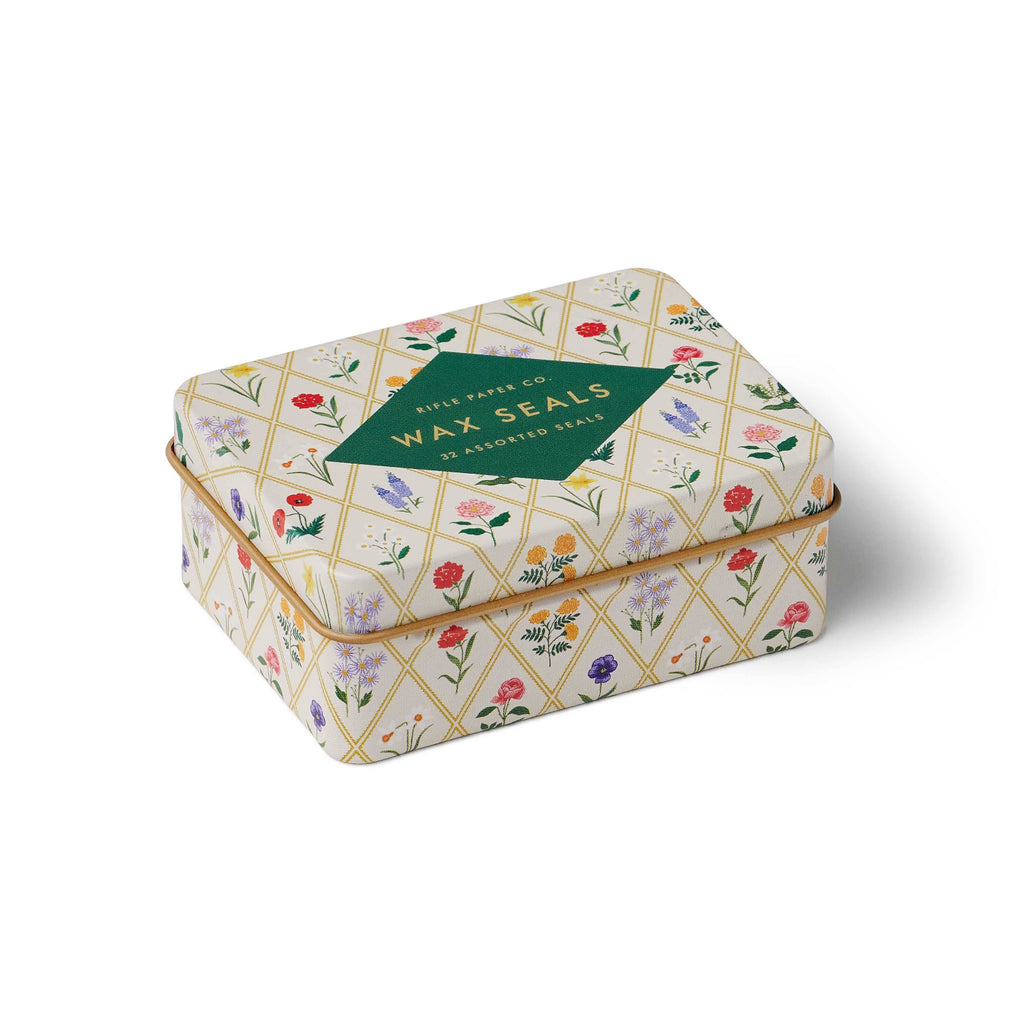 Decorative tin box with floral pattern on a white background