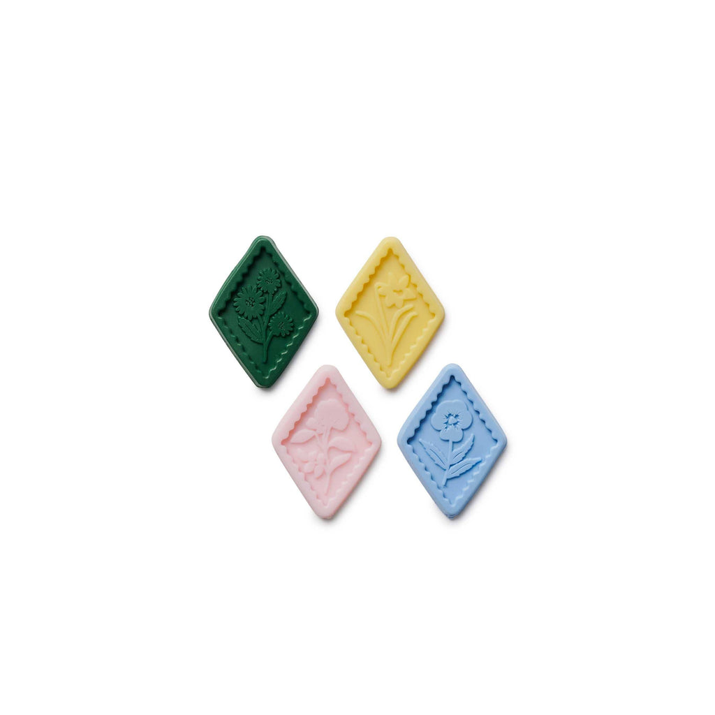 Four colorful square stones on a white background