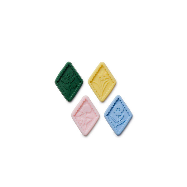 Four colorful square stones on a white background