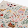 Embroidered fabric with 'Home Sweet Home' text and various decorative elements on a white background