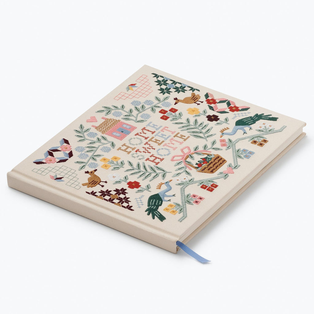 Notebook with decorative cover featuring illustrations on a white background