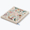 Notebook with decorative cover featuring illustrations on a white background