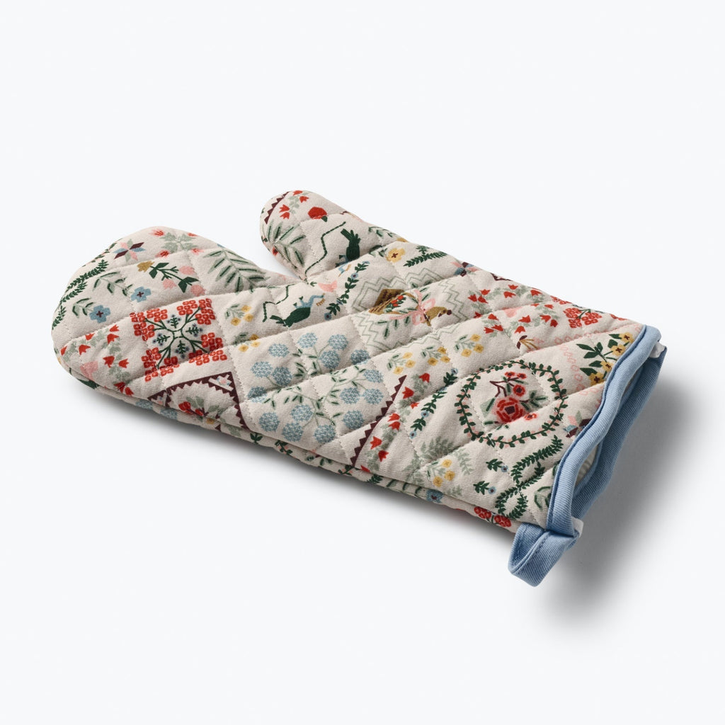 Floral patterned oven mitt on a white background