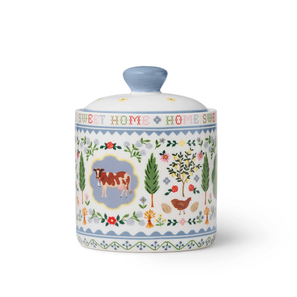 Decorative ceramic jar with farm animal illustrations and 'Sweet Home' text on a white background
