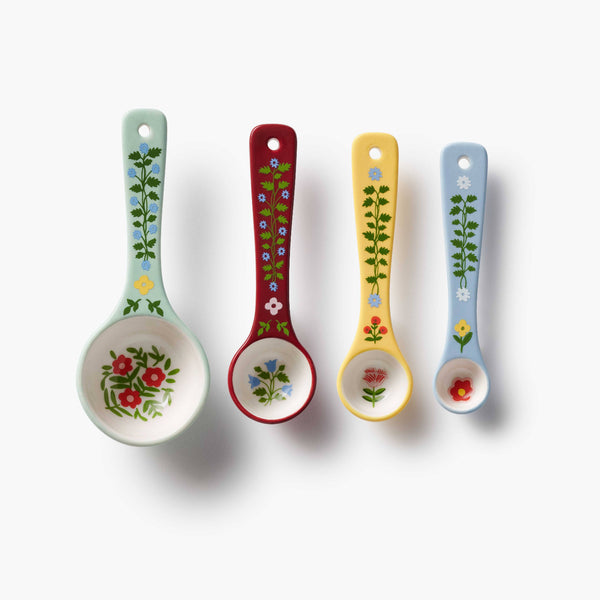 Four colorful spoons with floral patterns on a white background
