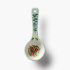 Decorative ceramic spoon with floral design on a white background