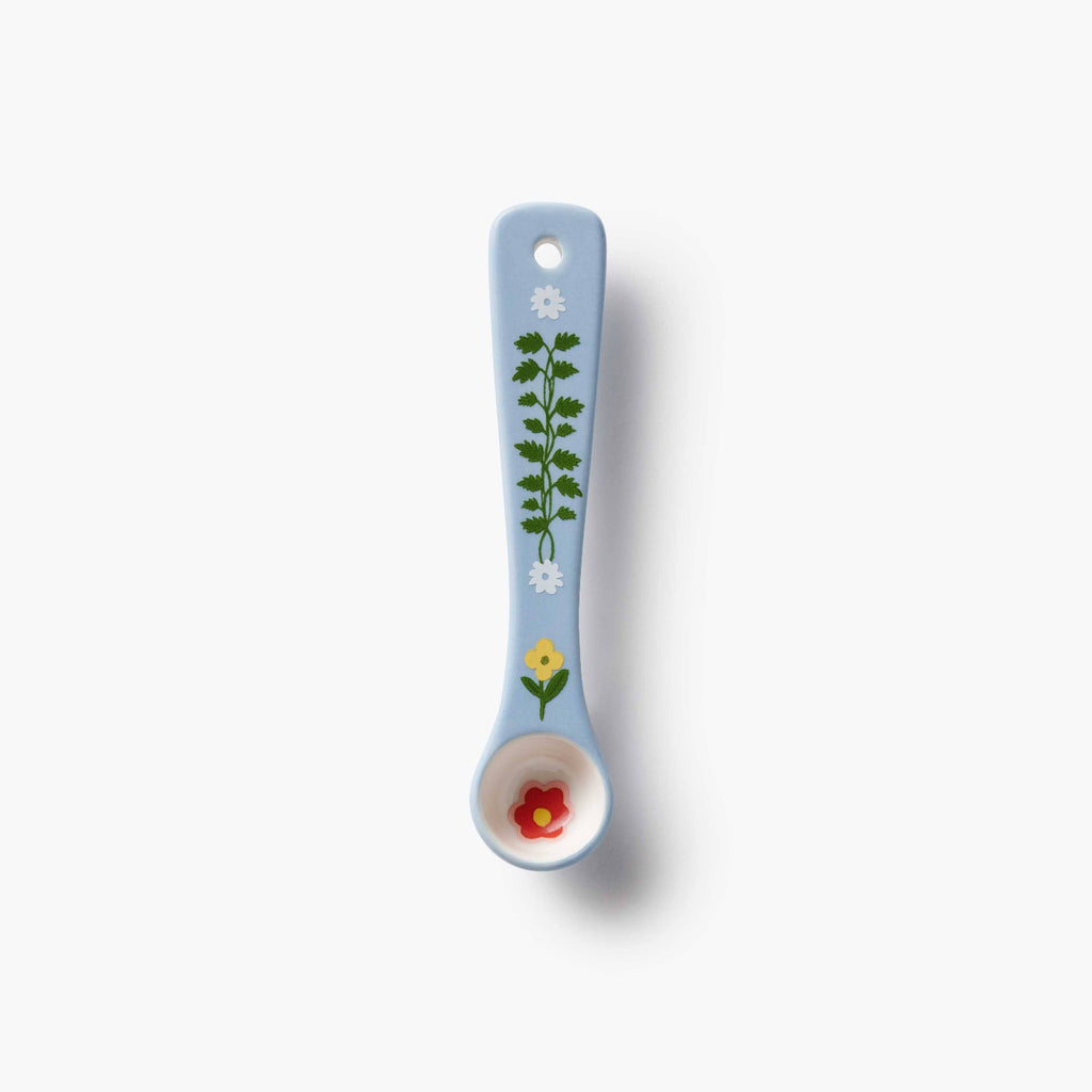 Decorative spoon with floral designs on a white background