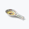Decorative ceramic spoon rest with rooster design on a white background