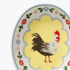 Decorative plate with a rooster design on a white background