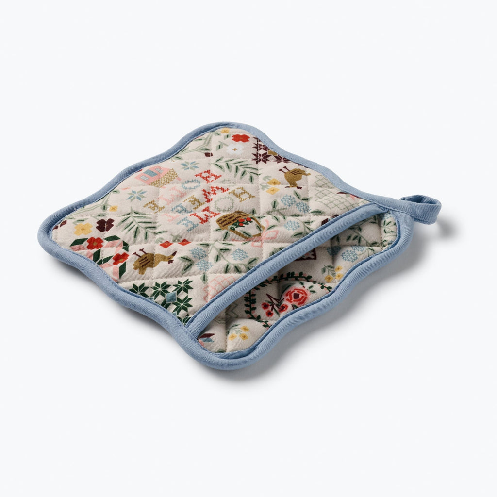 Floral patterned pot holder with blue border on a white background
