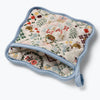 Quilted pot holder with floral and nature-themed design on a white background