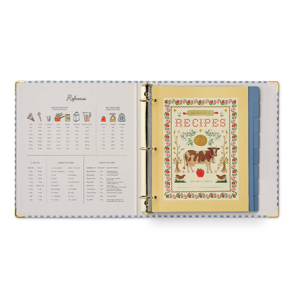 Open recipe book with colorful cover and text on a white background
