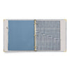 Open notebook with blue and gingham checkered pages on a white background