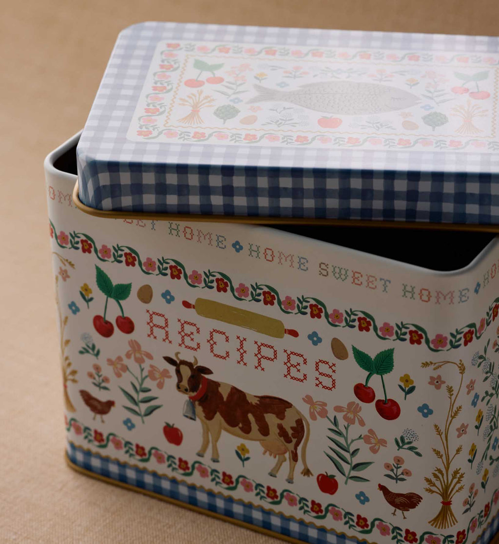 Decorative recipe box with farm-themed design on a beige background