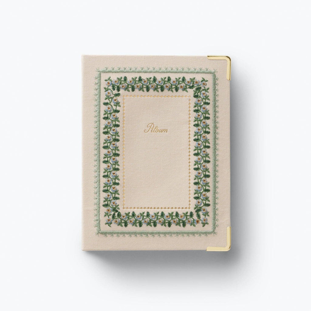 Small notebook with decorative green border on a white background