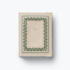 Small notebook with decorative green border on a white background