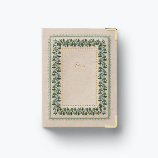 Small notebook with decorative green border on a white background