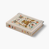 A decorative hardcover notebook or book with a cream-colored cover featuring a colorful embroidered-style illustration of a leopard, flowers, birds, and small motifs. The notebook is shown at an angle on a clean, light gray background.