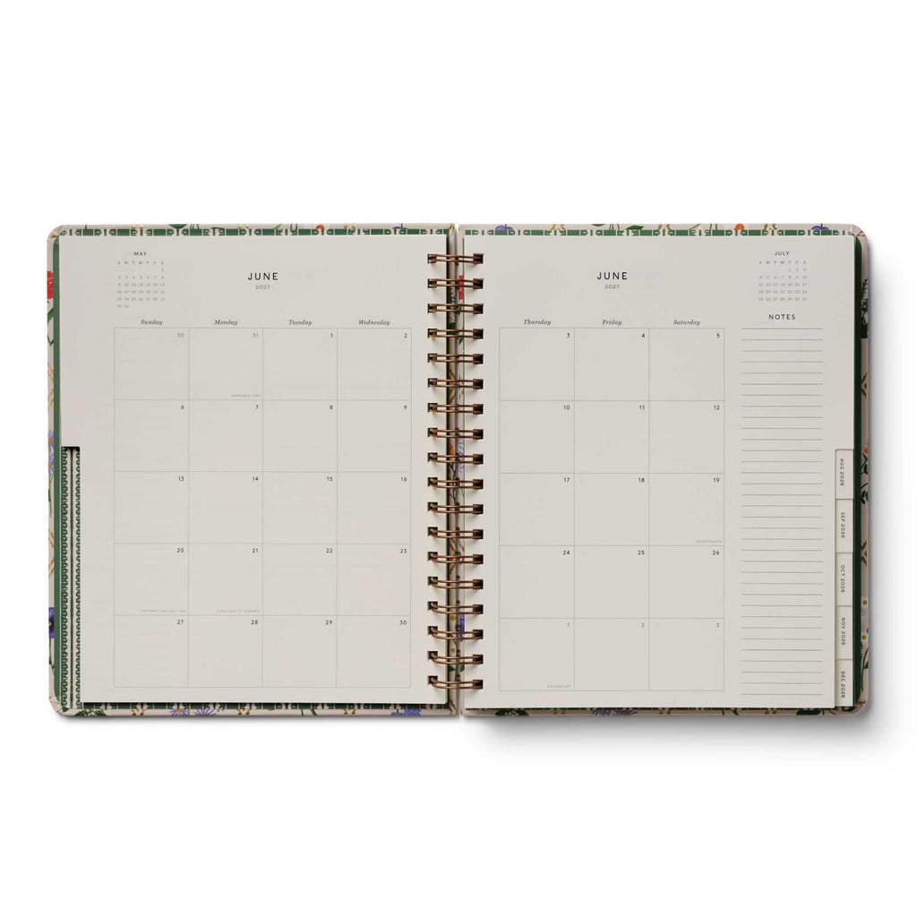 Open planner showing a two-page spread for June with a floral cover.