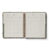 Open planner showing a two-page spread for June with a floral cover.