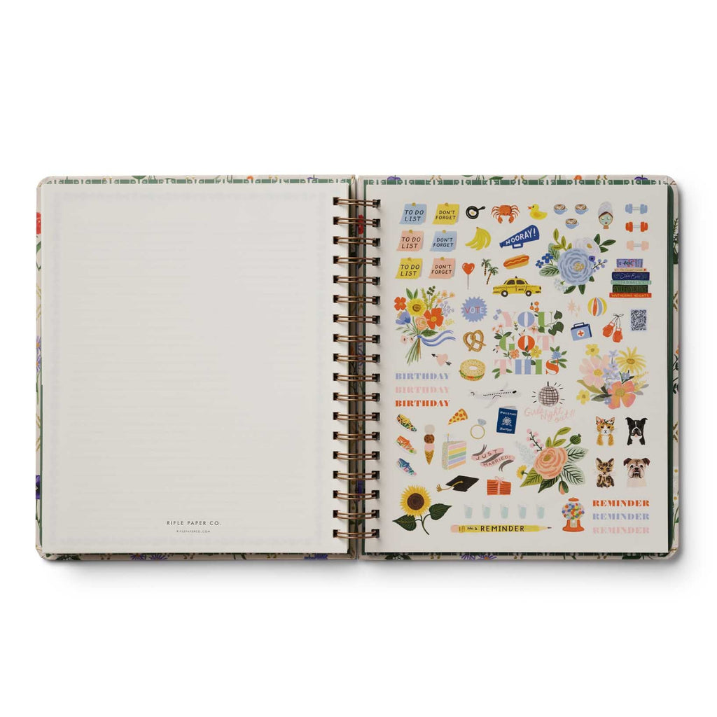 Open planner with sticker sheet on a white background
