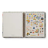 Open planner with sticker sheet on a white background