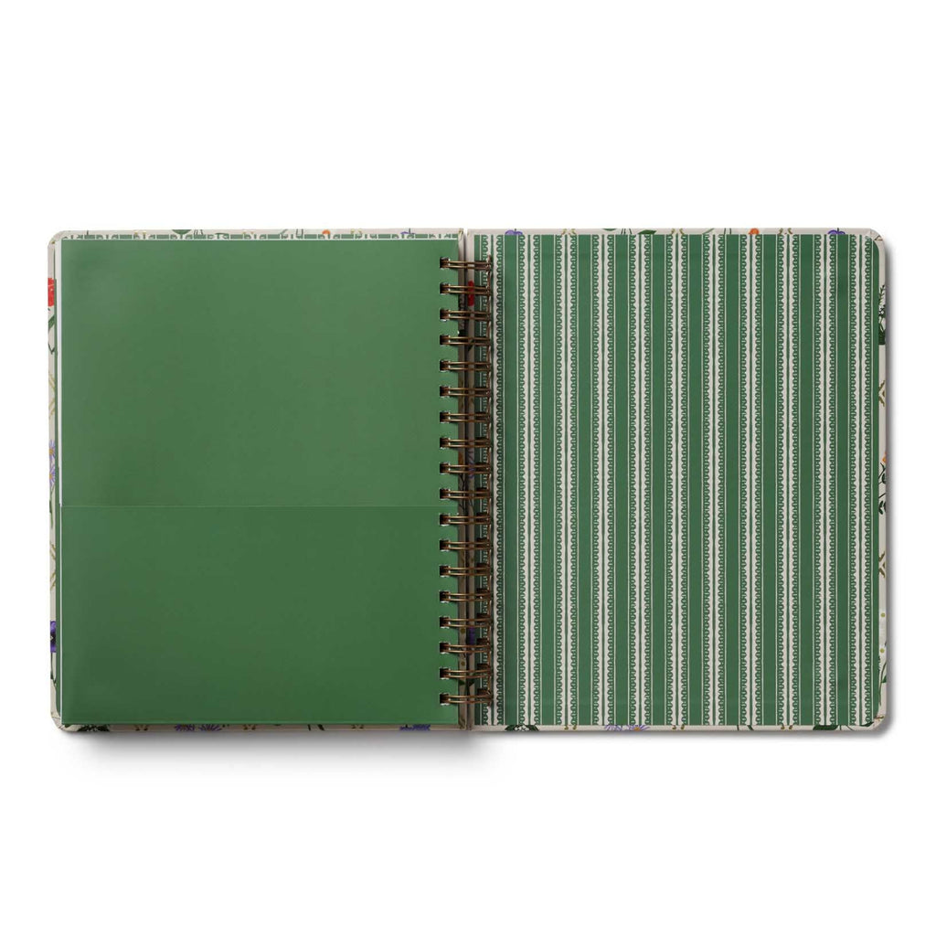 Open notebook with green cover and striped interior on a white background