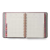 Open planner with colorful border on a white background