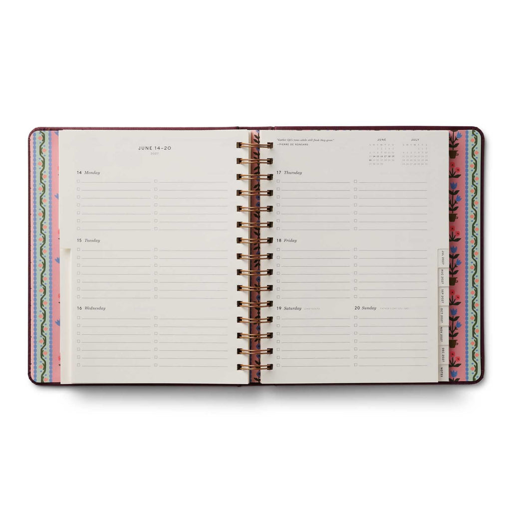 Open planner with colorful spine on a white background