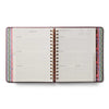 Open planner with colorful spine on a white background