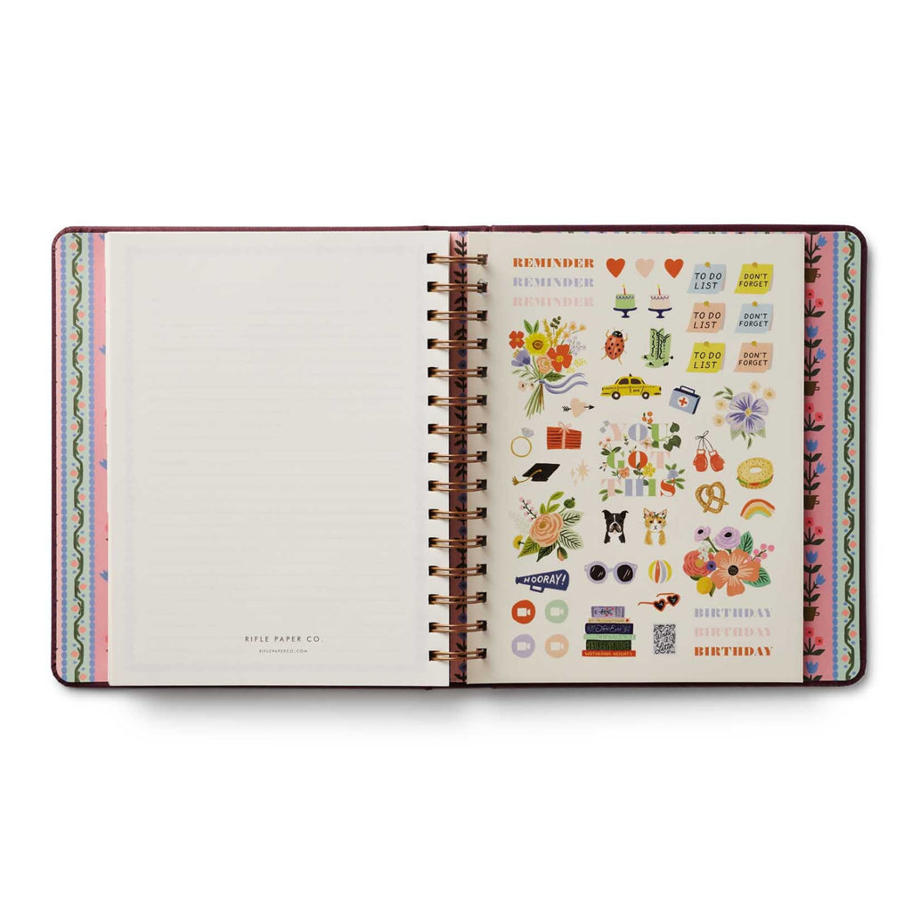 Open planner with colorful stickers on a white background