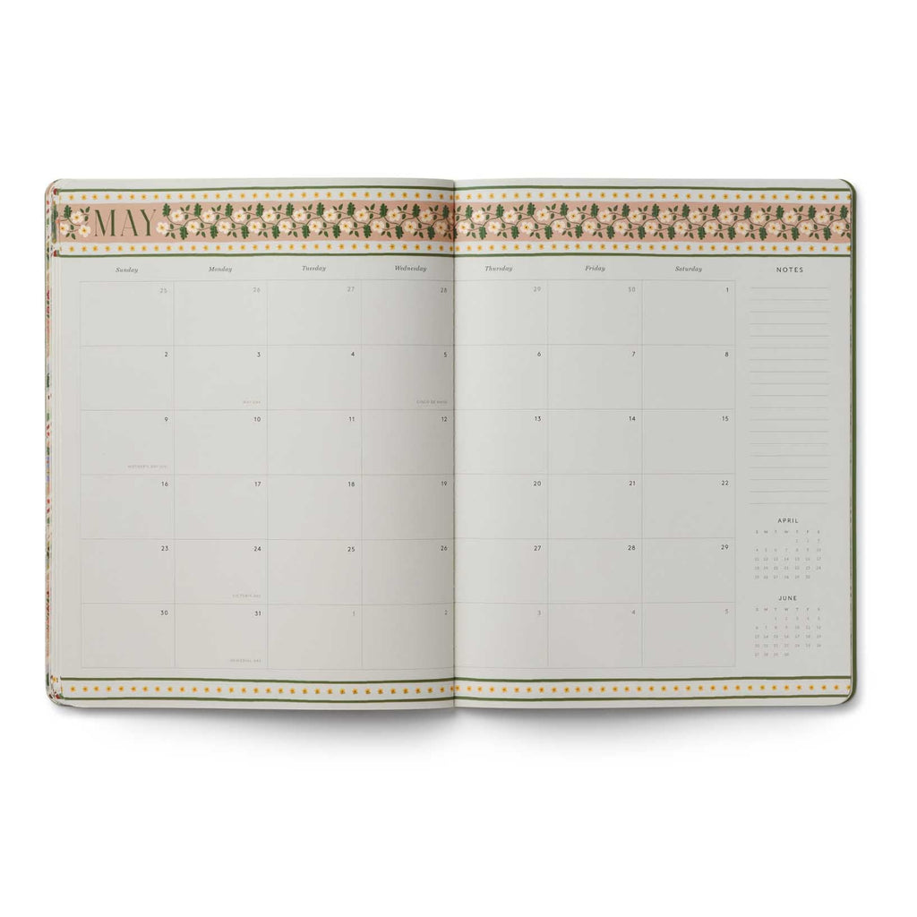 Open planner with decorative cover on a white background