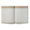 Open planner with decorative cover on a white background